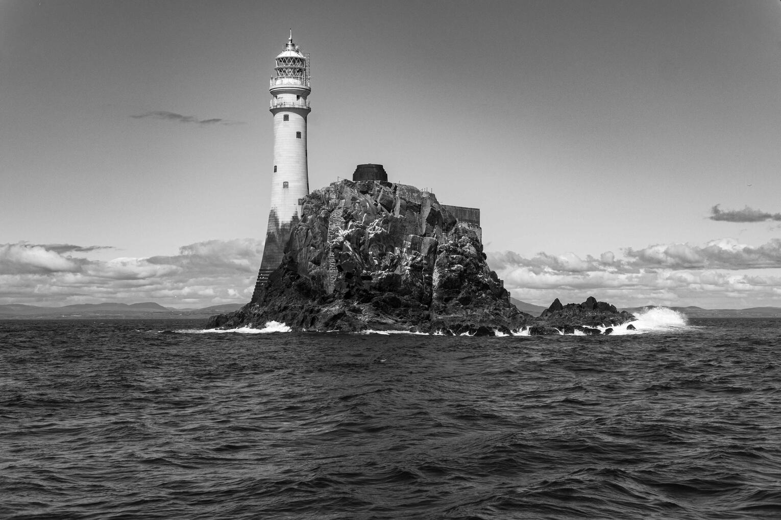 Fastnet: The Last Light Black and white photograph of Fastnet Lighthouse standing on its rocky island off the coast of West Cork, Ireland.